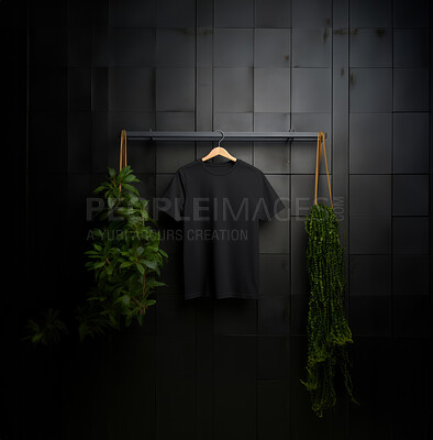 Black t-shirt mockup with copyspace on dark background with plants on hanger, front view
