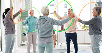 Buy stock photo Fitness, senior and people with hula hoop at the gym for training, workout and health in retirement. Happy, together and a group of elderly friends with a coach and gear for an exercise class