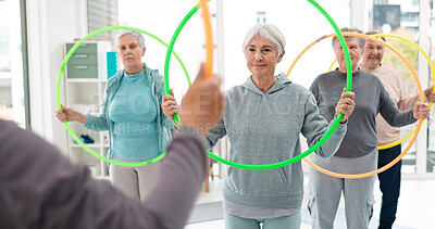 Fitness, senior and people with hula hoop at the gym for training, workout and health in retirement. Happy, together and a group of elderly friends with a coach and gear for an exercise class