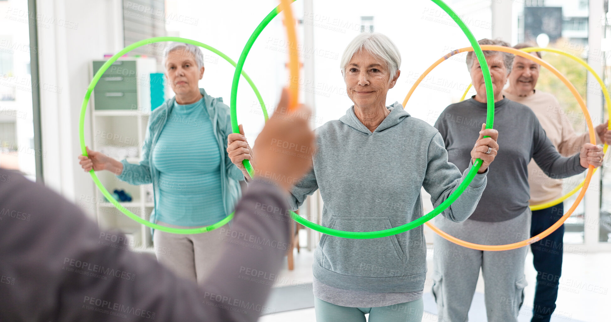 Buy stock photo Fitness, senior and people with hula hoop at the gym for training, workout and health in retirement. Happy, together and a group of elderly friends with a coach and gear for an exercise class