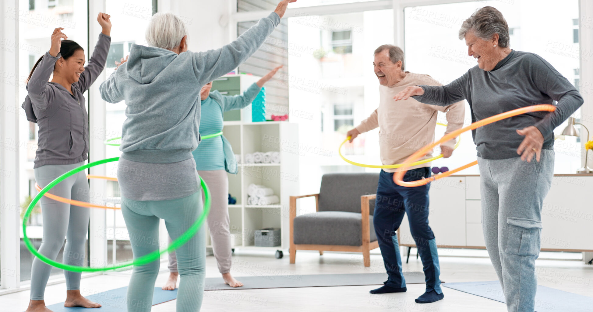 Buy stock photo Fitness, senior and people with hula hoop at the gym for training, workout and health in retirement. Happy, together and a group of elderly friends with a coach and gear for an exercise class