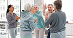 Fitness, hands together and senior people for exercise support, celebration and teamwork in workout class. Exercise, training goal and group of elderly man and women with high five for health success