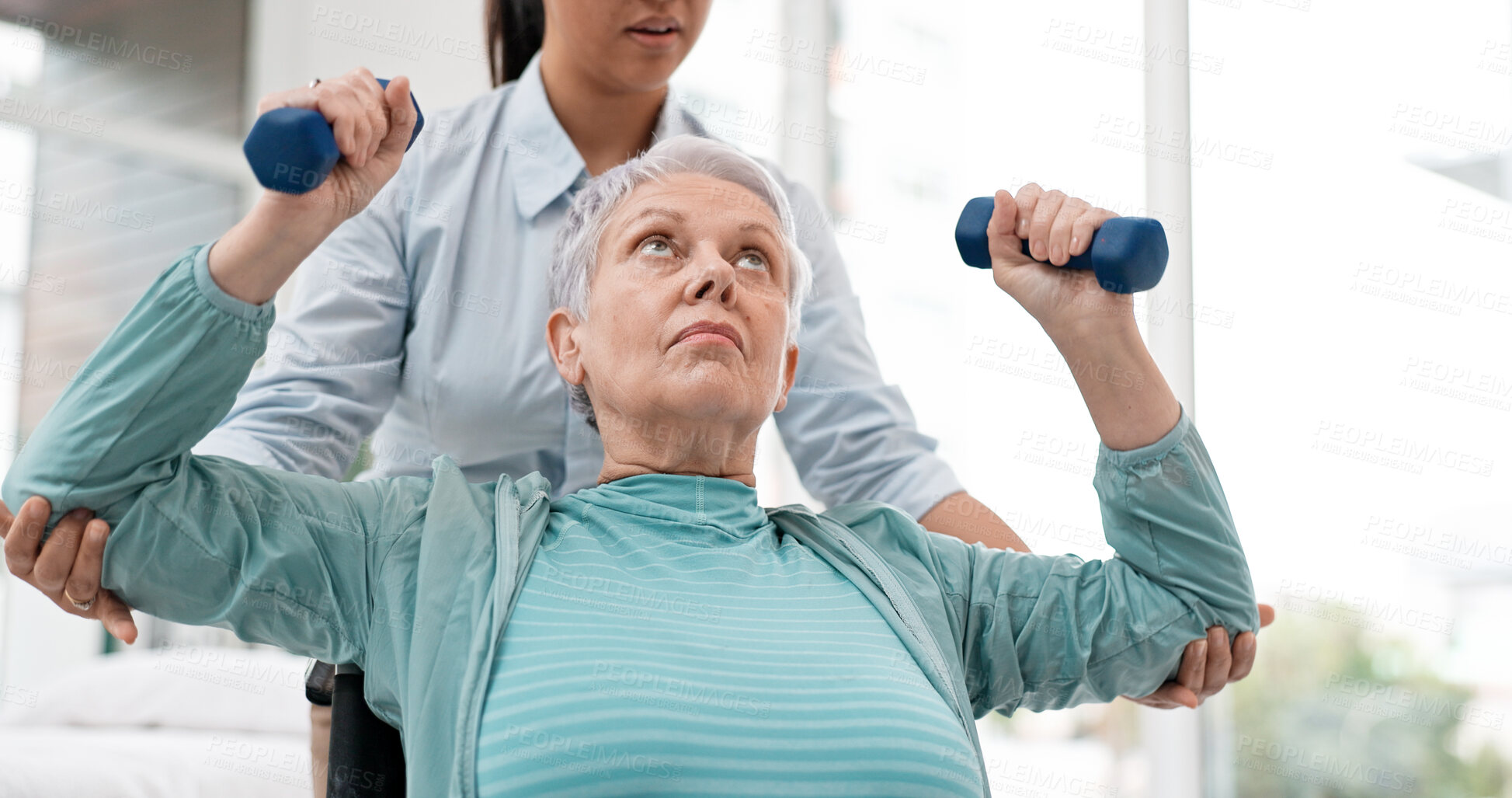 Buy stock photo Woman with disability, physiotherapy and dumbbell exercise of healthcare rehabilitation, consulting or physical therapy assessment. Clinic, physiotherapist and support of senior patient in wheelchair