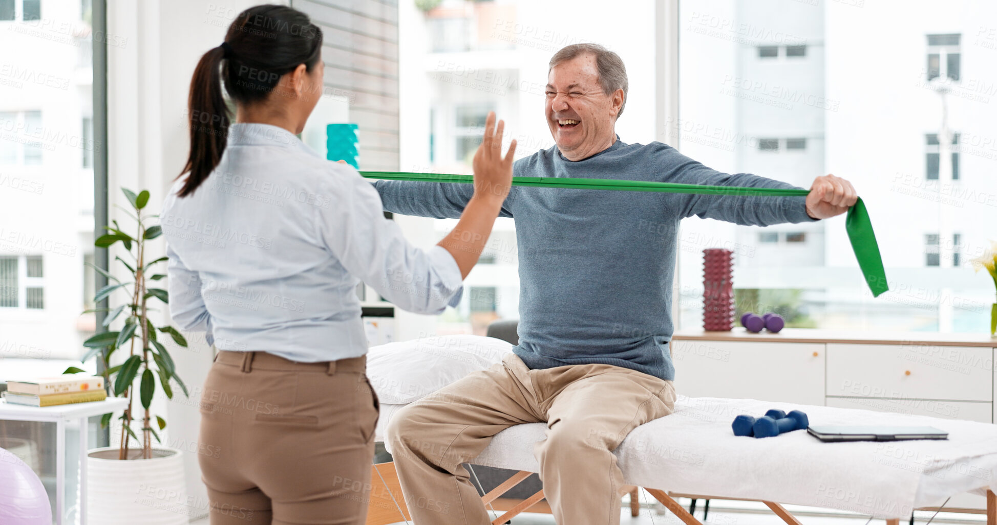 Buy stock photo Physical therapy, patient and chiropractor, stretching with resistance band and muscle with high five. Help, support and woman with old man at clinic, elderly care and fitness with physio success