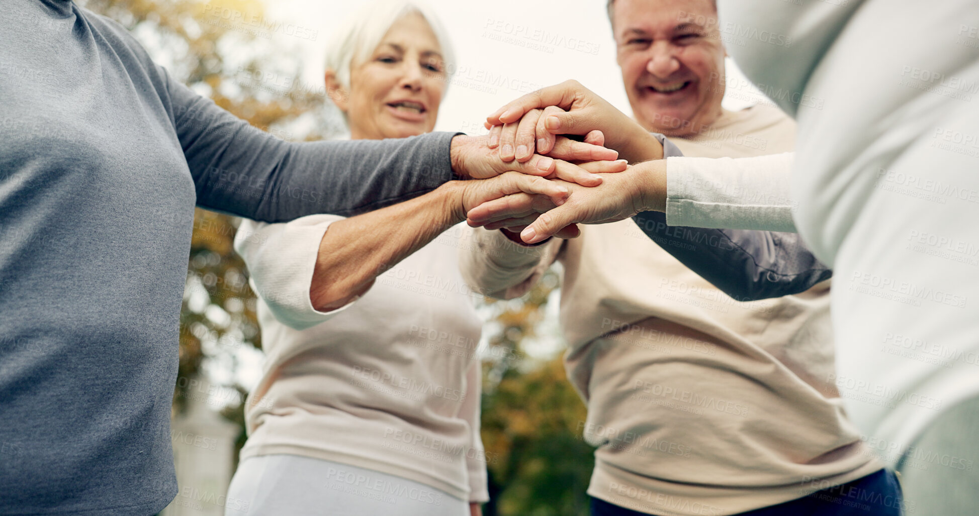Buy stock photo Hands stacked, senior and people in nature for motivation, support and team building in retirement. Excited, together and group of elderly friends with gesture for solidarity and community at a park