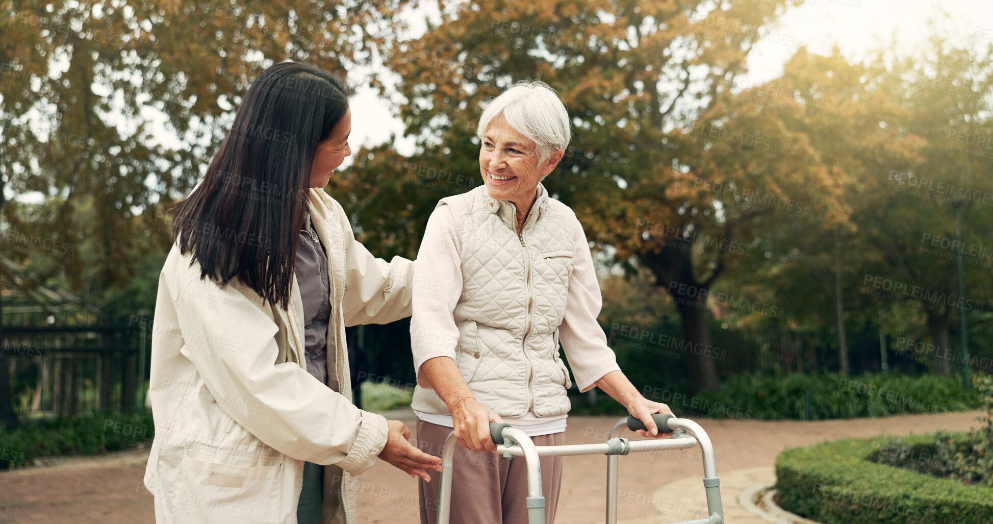 Buy stock photo Park, walker and woman help senior walking as support, trust and care for morning healthcare exercise or workout. Health, physical therapy and elderly with caregiver for outdoor rehabilitation
