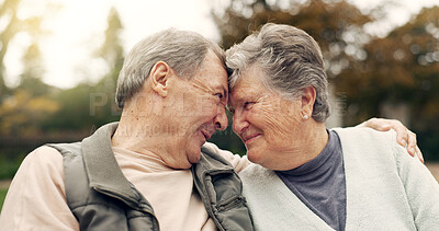 Forehead, touch and senior couple in a park with love, happy and conversation with romantic bonding. Fun, old people and elderly man embrace woman with care, romance or soulmate connection outdoor