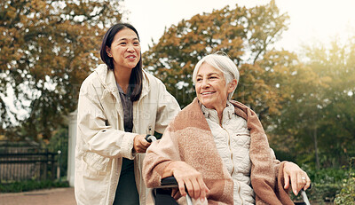 Buy stock photo Elderly woman, wheelchair and nurse in park, nature or garden outdoor. Happy, senior person with a disability and walking with caregiver for health, wellness and physical therapy for rehabilitation