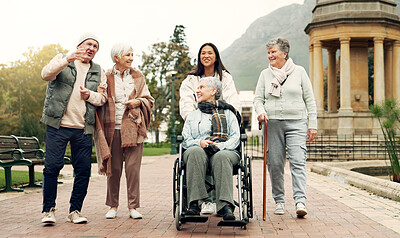 Buy stock photo Retirement, walking and elderly friends in park for bonding, wellness and quality time together outdoor. Wheelchair, health and senior man and women with caregiver for fresh air, nature and relax