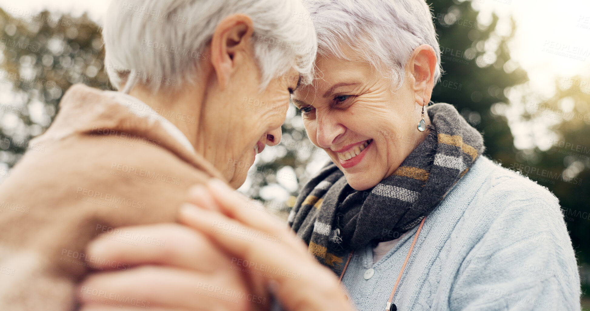 Buy stock photo Love, connection and senior women being affection for romance and bonding on an outdoor date. Nature, commitment and elderly female couple in retirement with intimate moment in a green garden or park