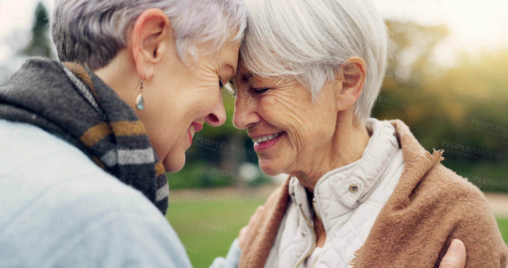 Buy stock photo Love, connection and senior women being affection for romance and bonding on an outdoor date. Nature, commitment and elderly female couple in retirement with intimate moment in a green garden or park