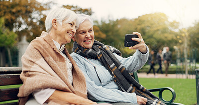 Senior, women and selfie in a park happy, bond and relax in nature on a bench together. Friends, old people and ladies smile for social media, profile picture or memory in forest chilling on weekend
