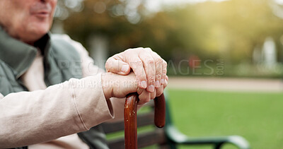 Hands, cane and elderly man in nature for walking for fresh air, exercise or peace in a park. Environment, closeup and senior male person in retirement with a stick for support in outdoor garden.