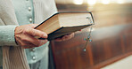 Walking, bible or hands of woman in church ready to worship God, holy spirit or religion in Christian cathedral. Faith, spiritual lady or person in chapel praying to praise Jesus Christ with rosary