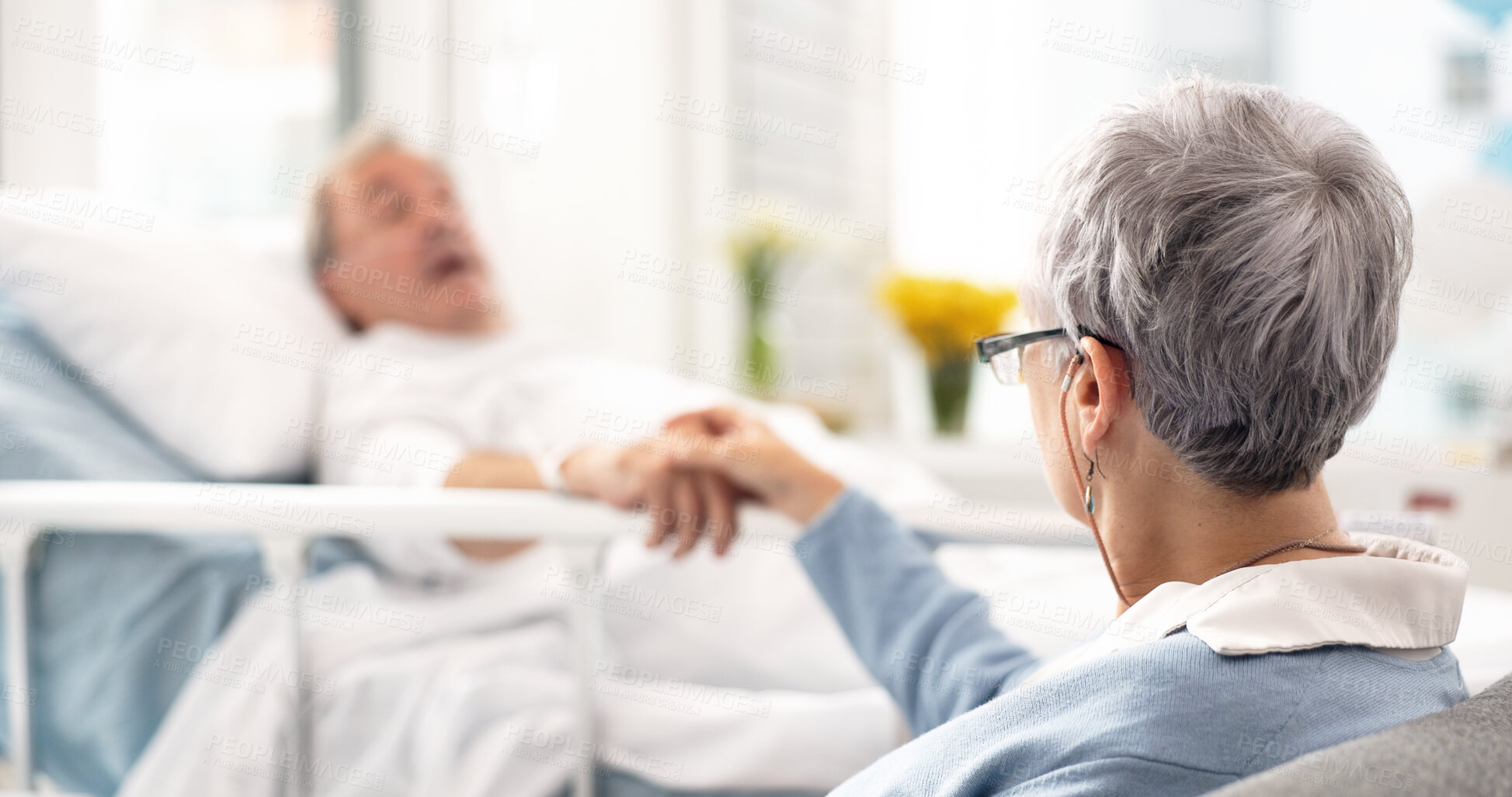 Buy stock photo Hospital, bed and senior couple holding hands, empathy and chat about recovery support, medical problem or rehabilitation. Retirement, clinic bedroom and elderly woman talking to sick cancer patient