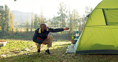 Camping, tent and black man setup in nature for shelter on outdoor holiday, vacation and adventure, Campsite, traveling and male person with hammer for pins for gear in woods, forest and countryside