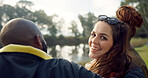 Happy, face and woman with friends on lake, camping in nature or group laughing and bonding on outdoor picnic at the park. Portrait, girl or smile in conversation, social gathering or relax in woods