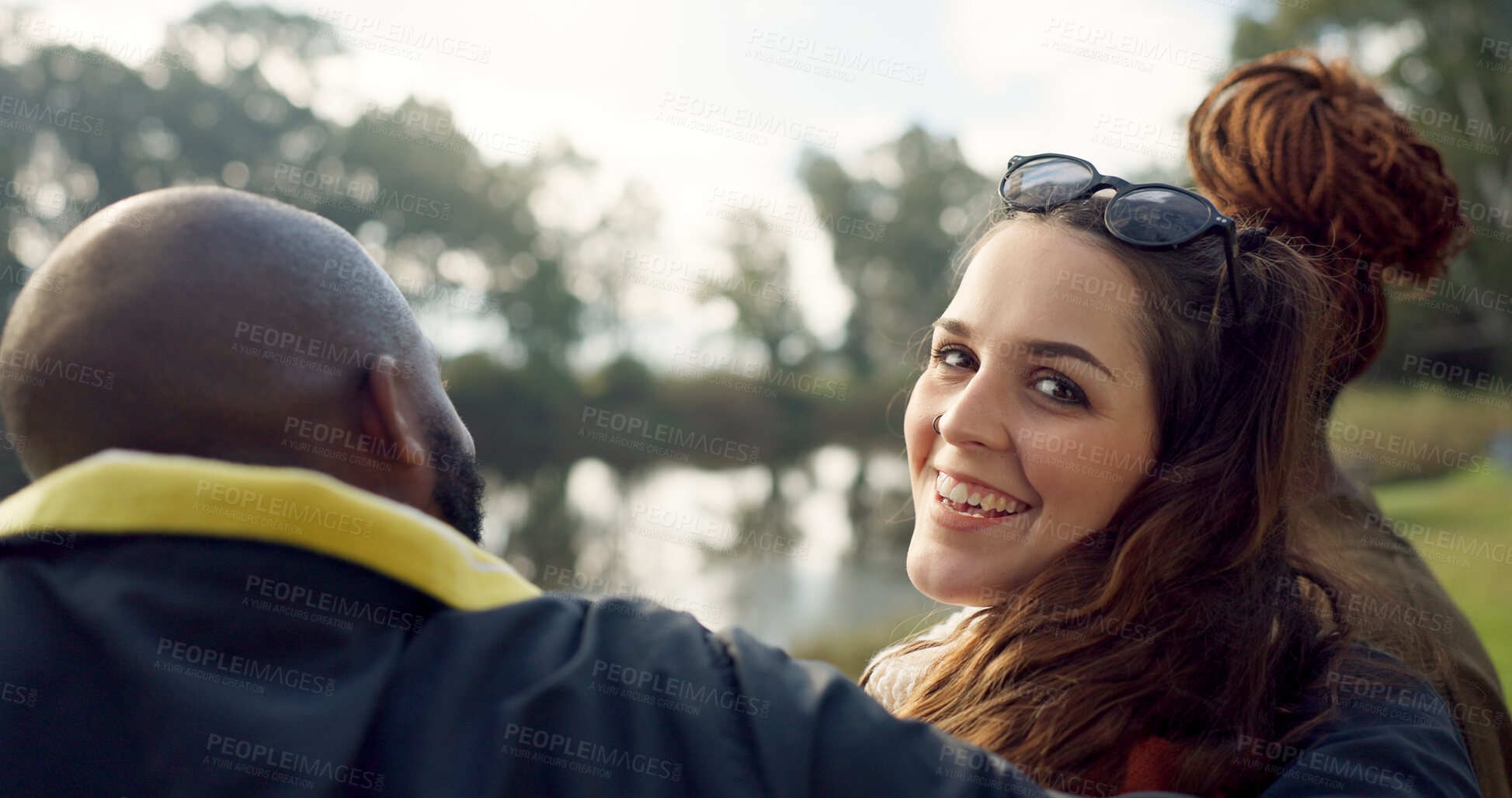 Buy stock photo Happy, face and woman with friends on lake, camping in nature or group laughing and bonding on outdoor picnic at the park. Portrait, girl or smile in conversation, social gathering or relax in woods