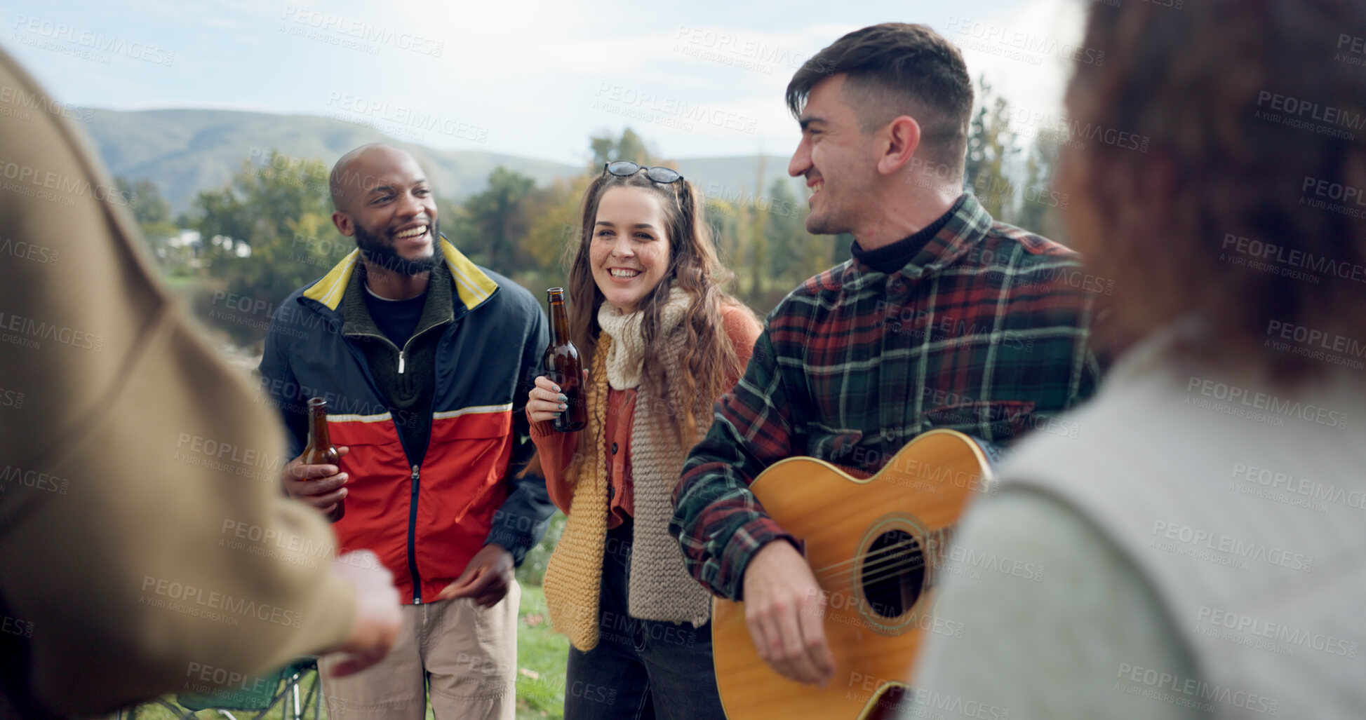 Buy stock photo Singing, camping or happy friends with guitar dancing together in nature, woods or park on vacation. Men, women or fun people with beer or drinks by bonfire or campfire for music in forest on holiday