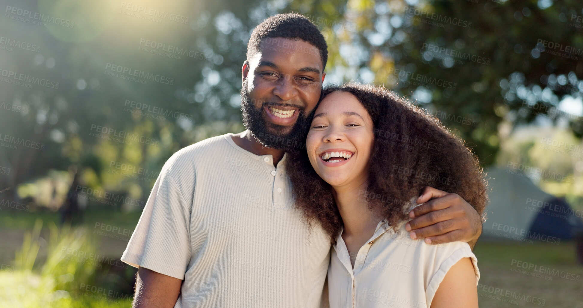 Buy stock photo Love, diversity and a camping couple hugging outdoor in nature together while bonding for adventure. Summer, smile or romance with an interracial man and woman in the woods or forest to explore