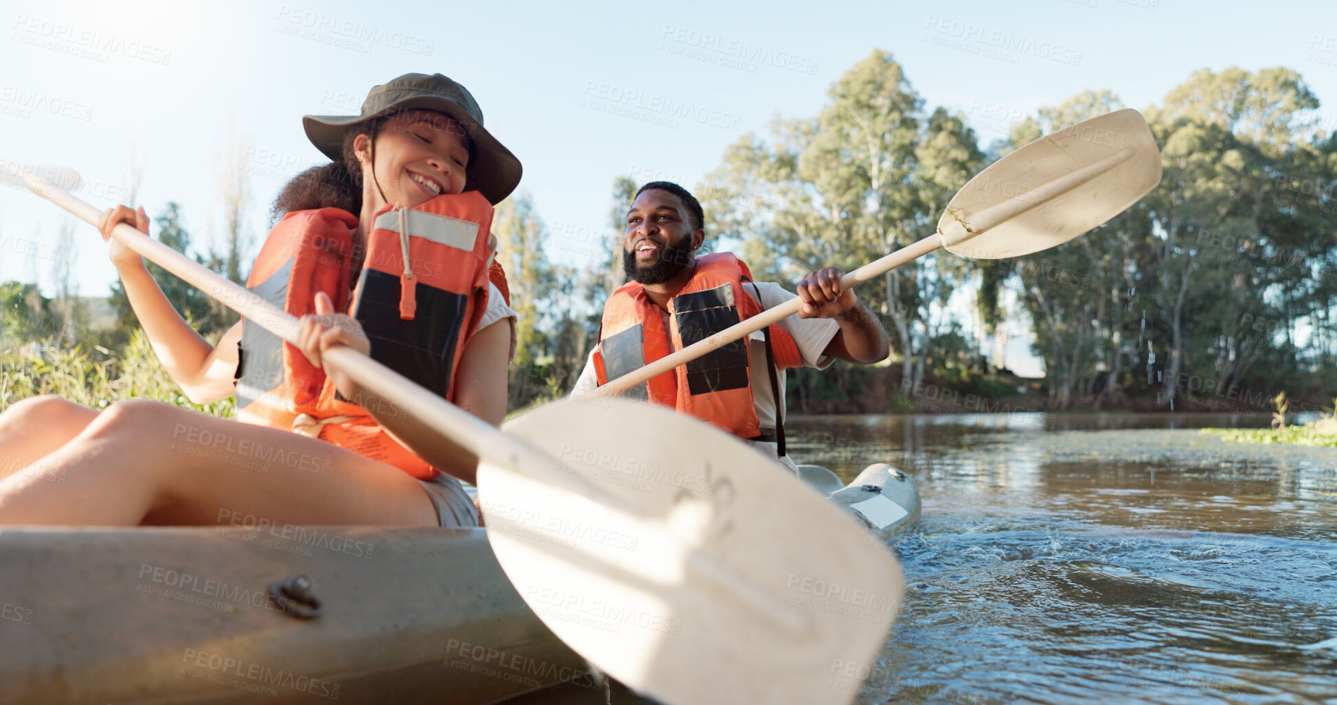 Buy stock photo Couple, kayak and rowing on a lake in nature for sports challenge, adventure or travel with a smile. Young man and woman friends together on boat and water for fitness, travel and holiday for freedom