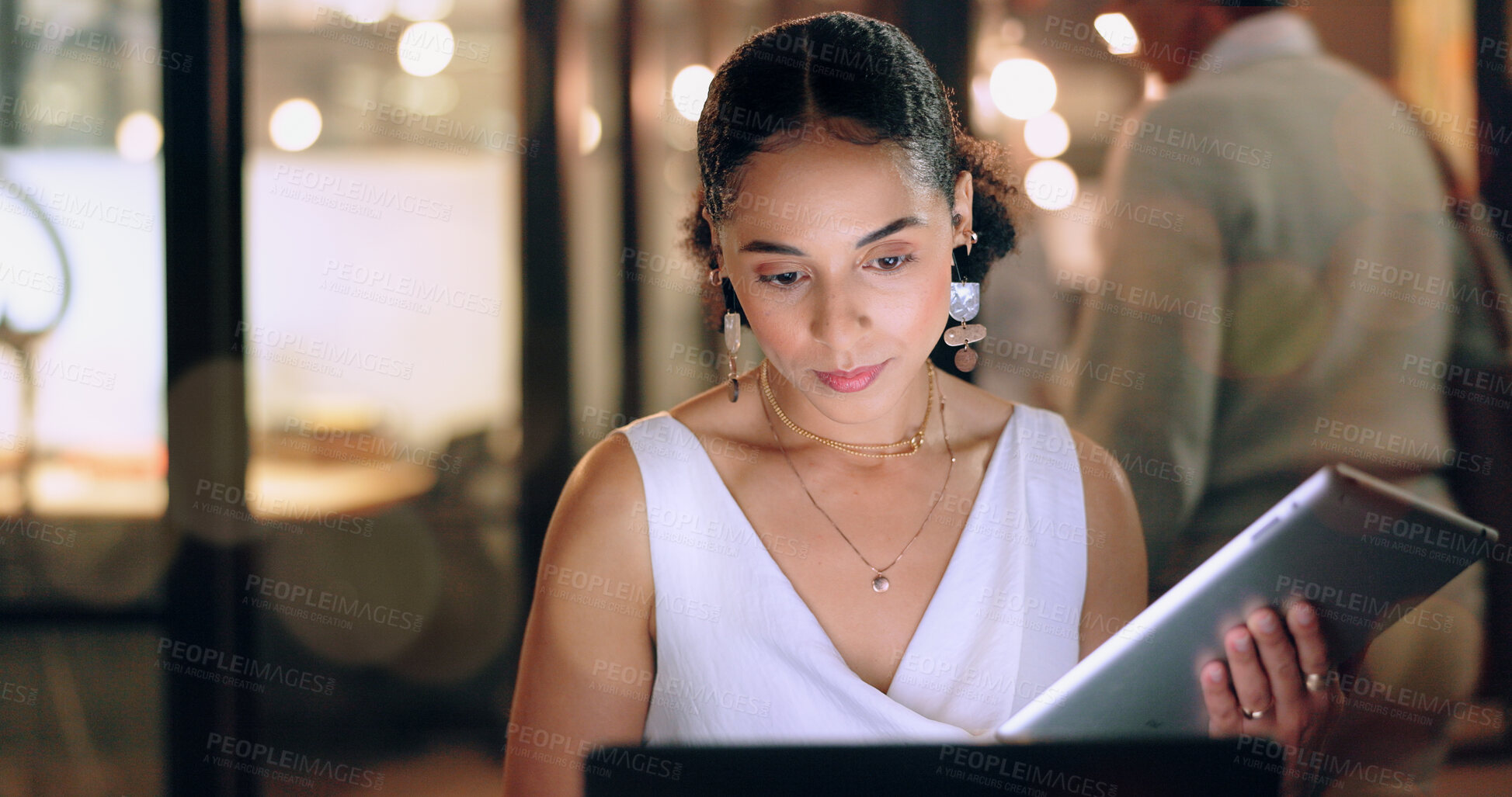 Buy stock photo Night office, tablet and business woman typing email, report or sales proposal. Overtime, technology or black female employee with touchscreen busy working late on marketing project in dark workplace