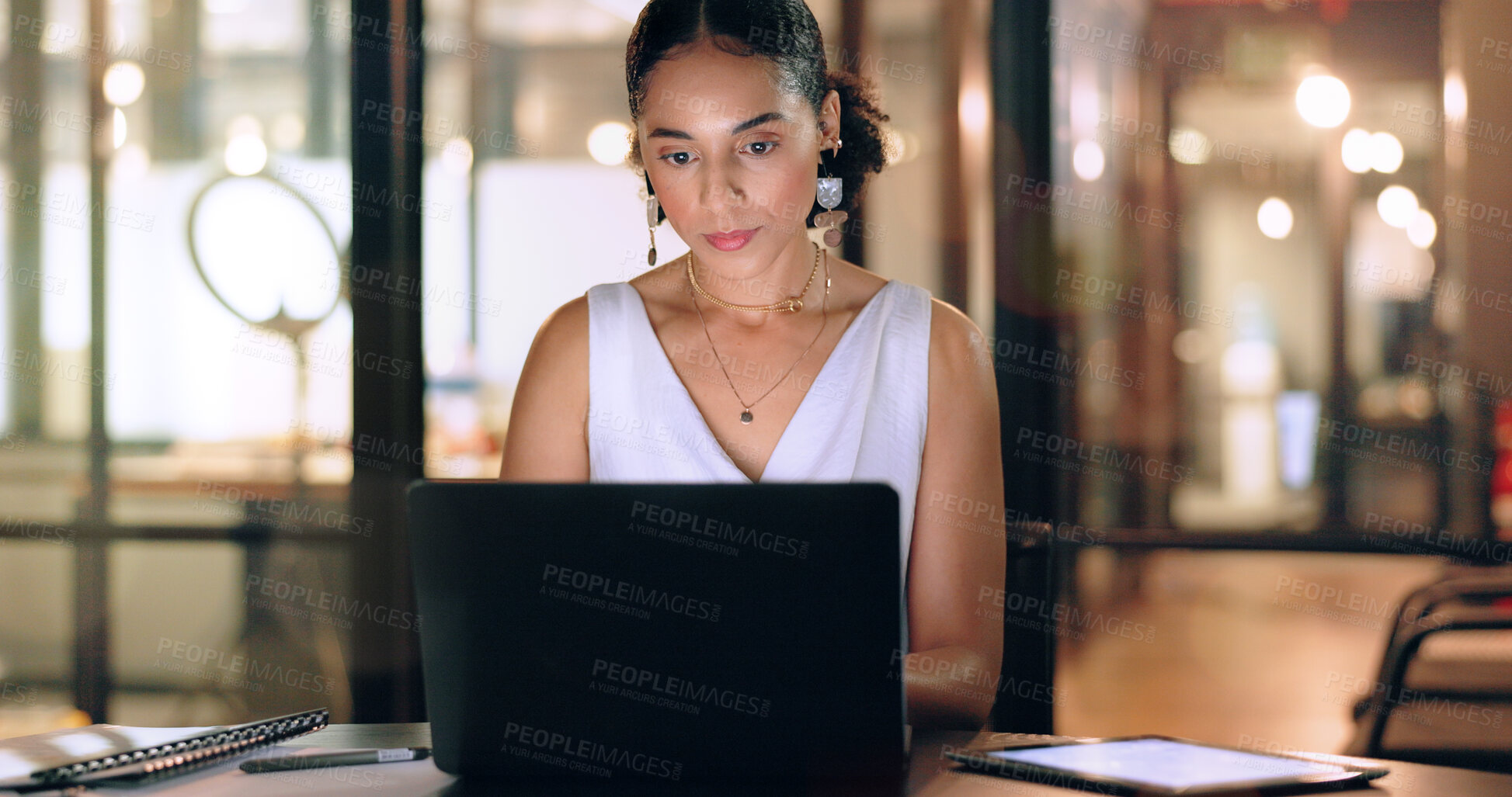 Buy stock photo Business woman with technology, typing and working night to meet deadline, kpi target and overtime with laptop and tablet. Black woman, corporate workplace and focus, schedule and overtime at office.