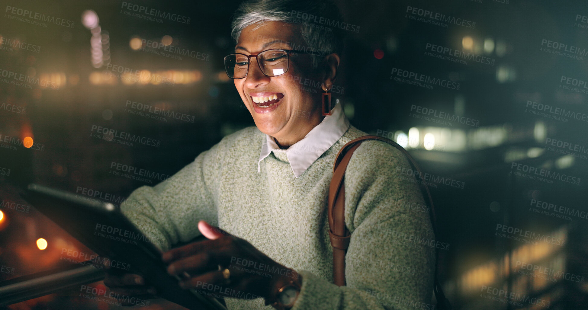 Buy stock photo Night, tablet and business woman laughing at comic meme or joke after finishing project. Social media, mature and happy female employee typing on touchscreen after working late in dark workplace.