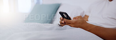 Typing, bed and hands of a man with a phone for social media, communication and chat. Contact, internet and guy scrolling on a mobile app for messages, reading emails or notification in the bedroom