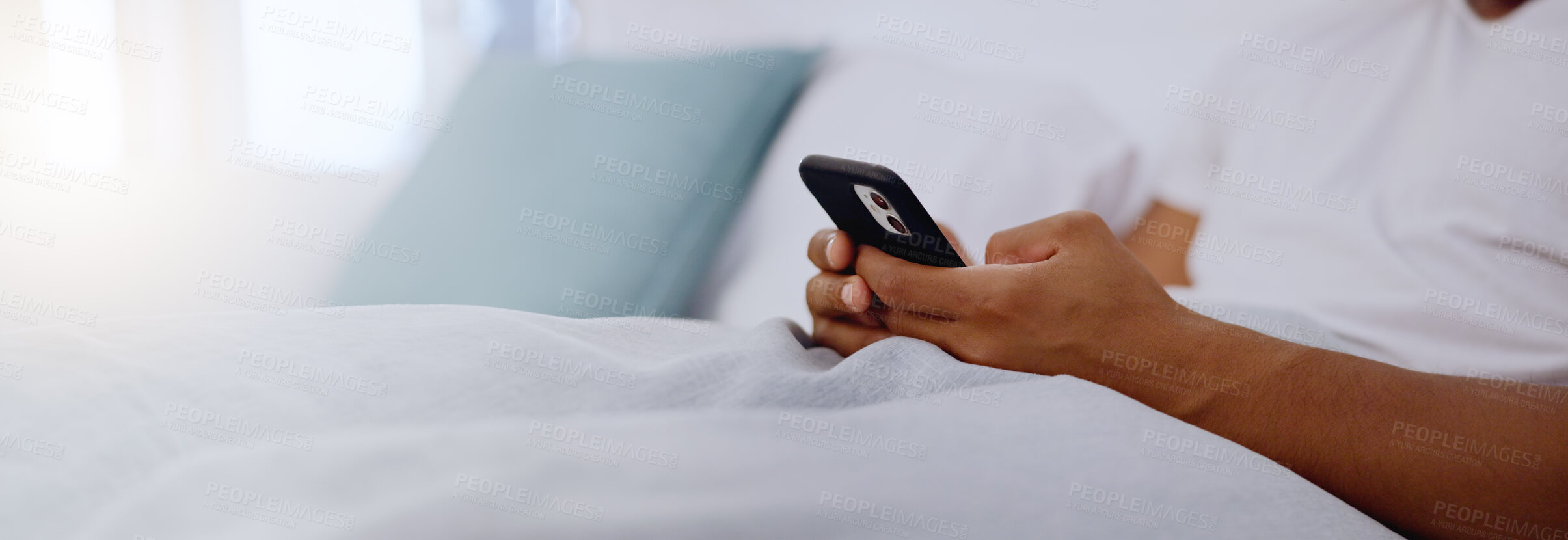 Buy stock photo Typing, bed and hands of a man with a phone for social media, communication and chat. Contact, internet and guy scrolling on a mobile app for messages, reading emails or notification in the bedroom