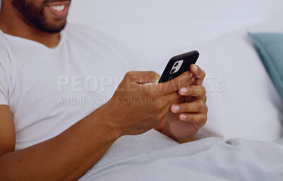 Typing, bed and hands of a man with a phone for social media, communication and chat. Contact, internet and guy scrolling on a mobile app for messages, reading emails or notification in the bedroom