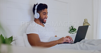 Movie, laughing and man in bed with a laptop for streaming, meme or comedy show online. Funny, relax and guy in the bedroom watching a film, subscription service or video on computer with headphones