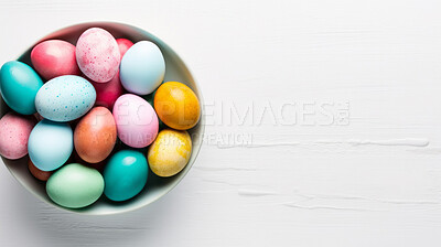 Bowl of colorful easter eggs on white copyspace background. Chocolate candy in studio