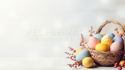 Basket of colorful easter eggs on white copyspace background. Chocolate candy in studio