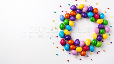 Circle of colorful easter eggs on white copyspace banner background. Festive candy in studio