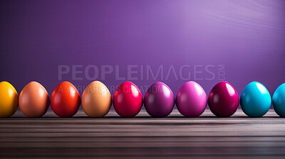 Row of colorful easter eggs on purple copyspace background. Chocolate candy in studio