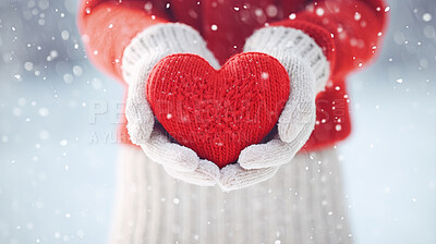 Hands holding knitted red heart on snowy copyspace. Love, friendship concept.