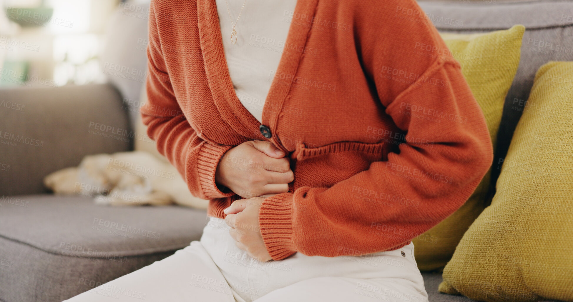 Buy stock photo Stomach ache, cramps and hands of woman with abdomen pain due to constipation, menstruation or ibs issue. Sick, home and person suffering and holding belly in a house lounge, couch and living room