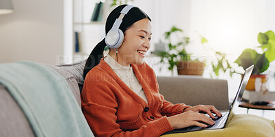 Laptop, headphones and asian woman on couch with work from home opportunity in online or website copywriting. Remote worker or person in china typing on her computer and listening to music at home