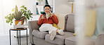 Asian woman, phone or music headphones on relax sofa in house or Japanese home living room. Smile,enjoy or happy student with mobile technology for podcast, dance radio or audio playlist app in comfort