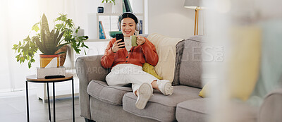 Asian woman, phone or music headphones on relax sofa in house or Japanese home living room. Smile,enjoy or happy student with mobile technology for podcast, dance radio or audio playlist app in comfort