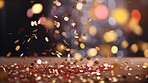 New Year celebration Festive background with falling confetti and bokeh lights.