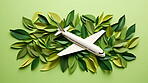 Airplane in leaves on green copyspace background. Sustainable travel, zero emissions travel concept