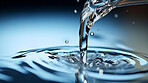 Pouring fresh spring mineral water for hydration. Flowing liquid close up with copy-space.