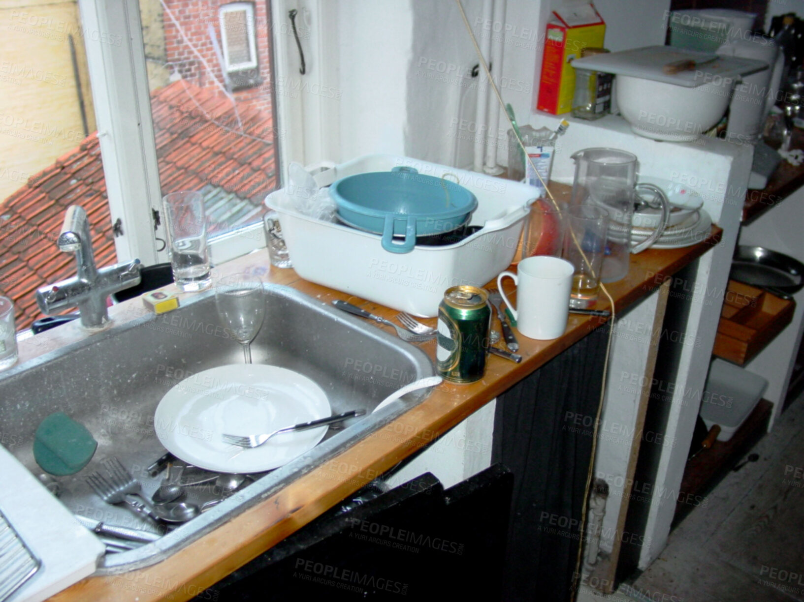 Buy stock photo Above messy and untidy kitchen sink with dirty dishes and empty beer bottles after a party. Start cleaning, glasses and cutlery in and around a sink in a filthy kitchen the morning after a fun night