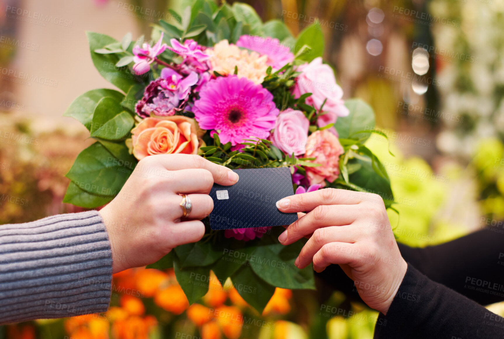 Buy stock photo Cropped shot of a woman buying flowers with her credit card from a florist