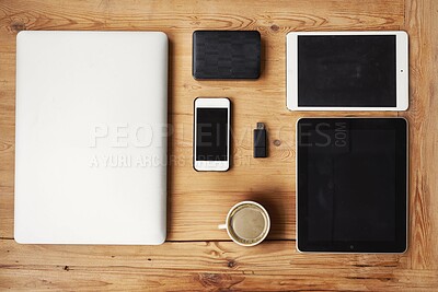 Buy stock photo High angle shot of wireless technology on a wooden table