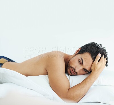 Buy stock photo Idea, relax and shirtless with a sexy man on a bed, lying in studio on a white background. Tattoo, thinking and topless with a handsome young male model posing in a bedroom for sensuality or desire