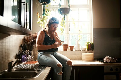 Buy stock photo Worried woman reading fake news on phone, searching social media or receiving bad news on technology during lockdown. Browsing or texting while looking stressed, concerned and anxious in home kitchen