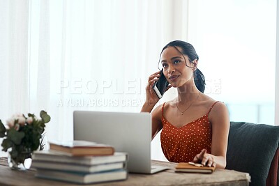 Buy stock photo Cropped shot of an attractive young businesswoman sitting in her office and using her laptop while on a phone call